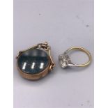 A 9ct gold ring with stone inset and a 9ct gold fob charm.