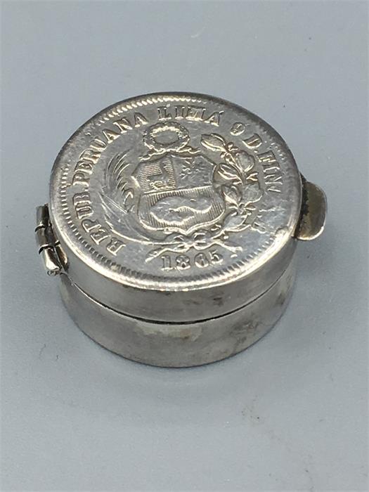 A small silver pill box with 1865 Peruvian 1 Dinero coin inset to lid