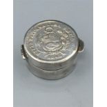 A small silver pill box with 1865 Peruvian 1 Dinero coin inset to lid