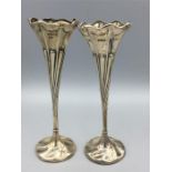 A pair of silver floral twisted vases by HW hallmarked 1902 and 1911