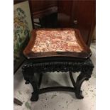 An Oriental marble topped table on claw and ball feet