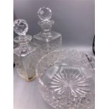 A selection of cut glass to include one bowl and two decanters