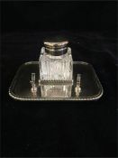 A silver plated and glass inkwell on stand with pen rest.