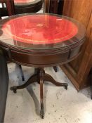 Red leather and glass topped drum table with two drawers