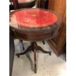 Red leather and glass topped drum table with two drawers