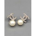 A Pair of Silver Chanel style earrings with pearl drops