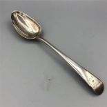 A hallmarked silver serving spoon