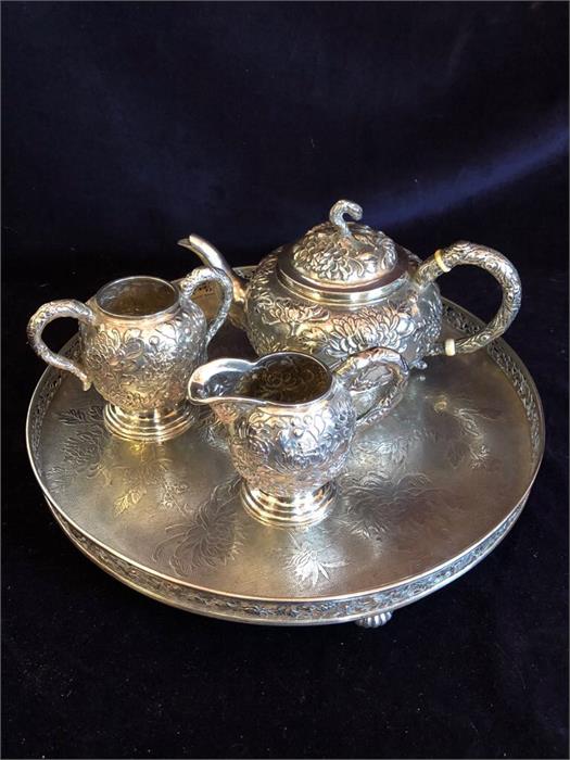 A Chinese silver tea set to include teapot, milk jug, sugar bowl and tray.