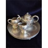 A Chinese silver tea set to include teapot, milk jug, sugar bowl and tray.