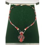 An Art Deco necklace in red and black enamel