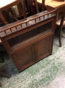 A wall hanging display cabinet with shelves and cupboard