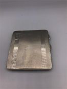 A silver cigarette case, hallmarked Birmingham, by J.C Ltd