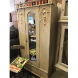 A Painted coat cupboard with hanging rail