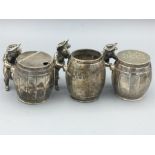 A set of three silver cruets in the shape of men moving barrels, hallmarked London 1975 made by