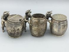 A set of three silver cruets in the shape of men moving barrels, hallmarked London 1975 made by