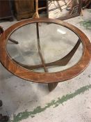 A Mid Century circular glass topped coffee table