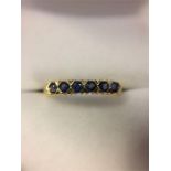 An 18ct Yellow Gold Ring set with six sapphires.