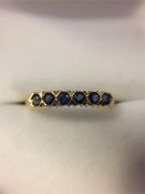 An 18ct Yellow Gold Ring set with six sapphires.