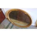 A gilt oval mirror