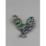 A Silver and Plique A Jour Rooster Brooch
