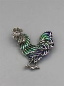 A Silver and Plique A Jour Rooster Brooch