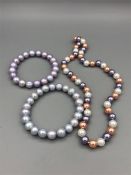 A Tri Color cultured pearl necklace with two bracelets