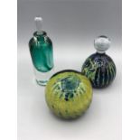 Three glass items to include two paperweights, one Mdina, and a scent bottle