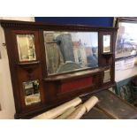 A dark wood over mantle with main mirror and four further small mirrors