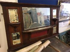 A dark wood over mantle with main mirror and four further small mirrors