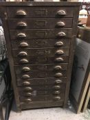 A Twelve drawer vintage metal filing cabinet with cup handles