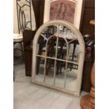 A tall arched out door mirror