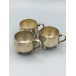 White metal cruets in the shape of mugs, marked 800 silver.