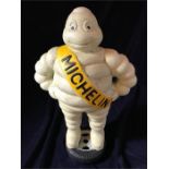 A Cast Iron Michelin Man standing on a tyre