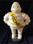 A Cast Iron Michelin Man standing on a tyre