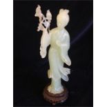 A Chinese Jade figure of a lady standing holding birds