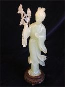 A Chinese Jade figure of a lady standing holding birds