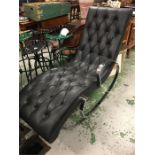 A black recliner with chrome arms