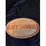 A Cast Iron Antiques Sign