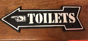 A cast iron Toilet arrow sign