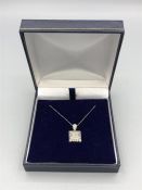 An 18ct White Gold diamond pendant on a gold chain