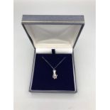 An 18ct White gold star shaped diamond pendant on gold chain