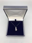 An 18ct White gold star shaped diamond pendant on gold chain