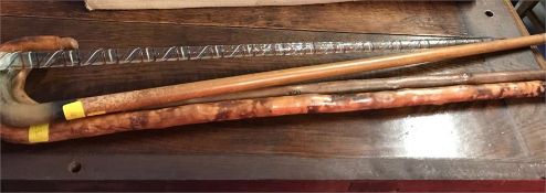 Four walking sticks to include Nail's glass, horn handle with silver band and two others