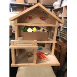 A Wooden Dolls House with wooden furniture
