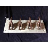 Dog tail hooks on a slate base