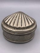 An Indian white metal box with a shell motif