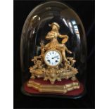 A Camerer & Kuss gilt clock under a glass dome.