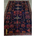 A Persian hand-knotted Hamadan blue-ground wool rug with multicoloured isometric designs single