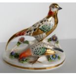 A Crown Staffordshire group of pheasants feeding, signed J.J. Jones to base, in good condition