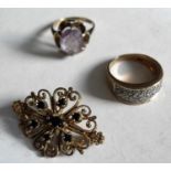 A diamond cluster ring, size L, a claw set amethyst ring, size G1/2 and a seven sapphire filigree